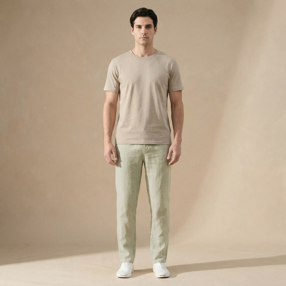 Man wearing light green Wesley men's linen summer pants with a straight leg, side pockets, and a beige tee.