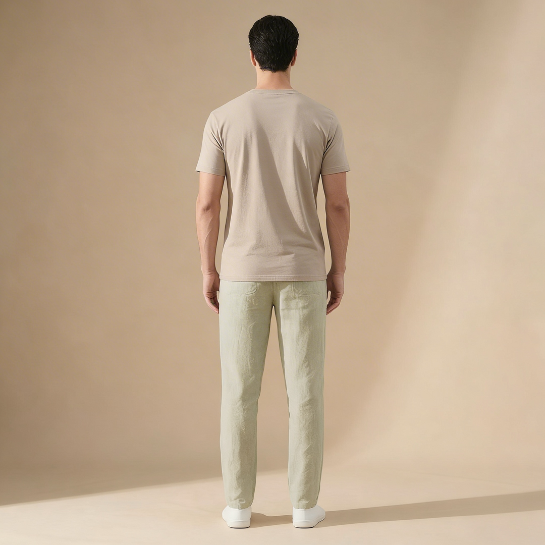 Man from behind wearing light green Wesley men's linen summer pants and a beige t-shirt.